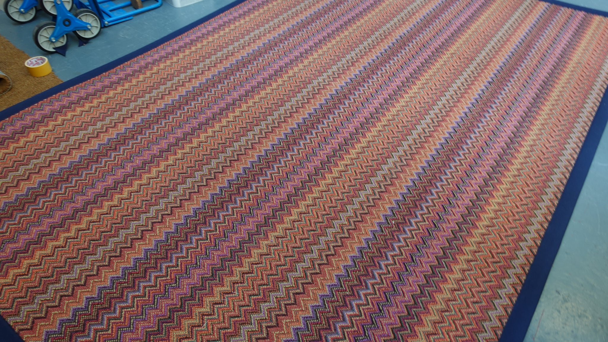Crucial Trading fabulous ruby patterned zigzag rug with a navy blue cotton border 100% New Zealand Wool