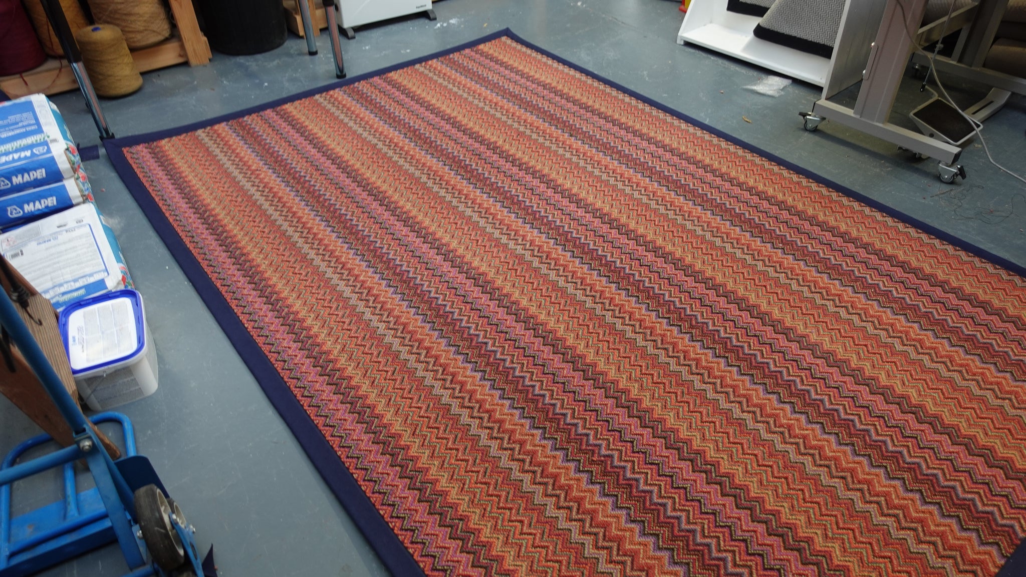 Crucial Trading fabulous ruby patterned zigzag rug with a navy blue cotton border 100% New Zealand Wool